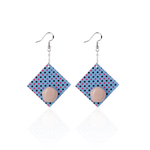 purple handcrafted earrings on white background