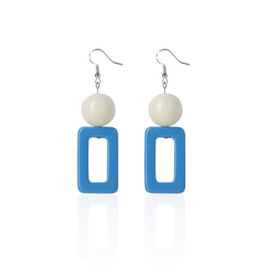 blue handcrafted earrings on white background