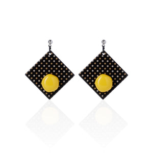 yellow handcrafted earrings on white background