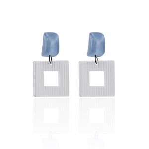 blue handcrafted earrings on white background