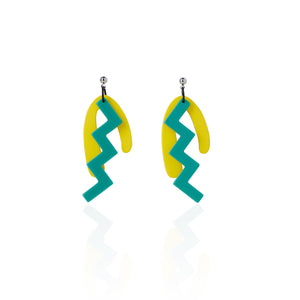 green and yellow irregular shape earrings on white background