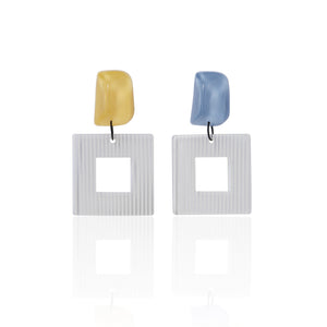 blue and yellow handcrafted earrings on white background