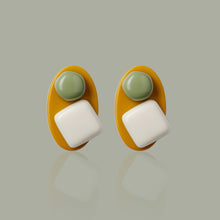 Load image into Gallery viewer,  white and green handmade niniwear earrings on green  background
