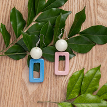 Load image into Gallery viewer, NINIWEAR blue and pink with pearl white round top handcrafted earrings on wooden background
