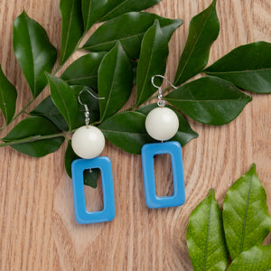 NINIWEAR blue hollow rectangle with white bead handcrafted earrings on wooden background