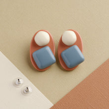 Load image into Gallery viewer, Morandi blue and pink handmade niniwear earrings on light brown background
