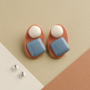 Morandi blue and pink handmade niniwear earrings on light brown background