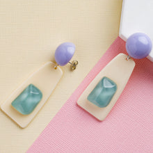 Load image into Gallery viewer, blue crystal stone handcrafted niniwear earrings on yellow and pink background
